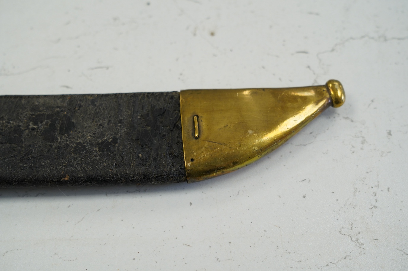 An 1855 Prussian infantry pioneer’s short sword, brass hilt stamped 12.A.1.10 in its brass mounted leather scabbard, blade 47.5cm. Condition - fair, some age wear